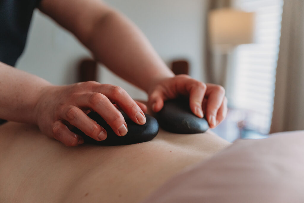 Image of Kristin Woudstra using hot stones